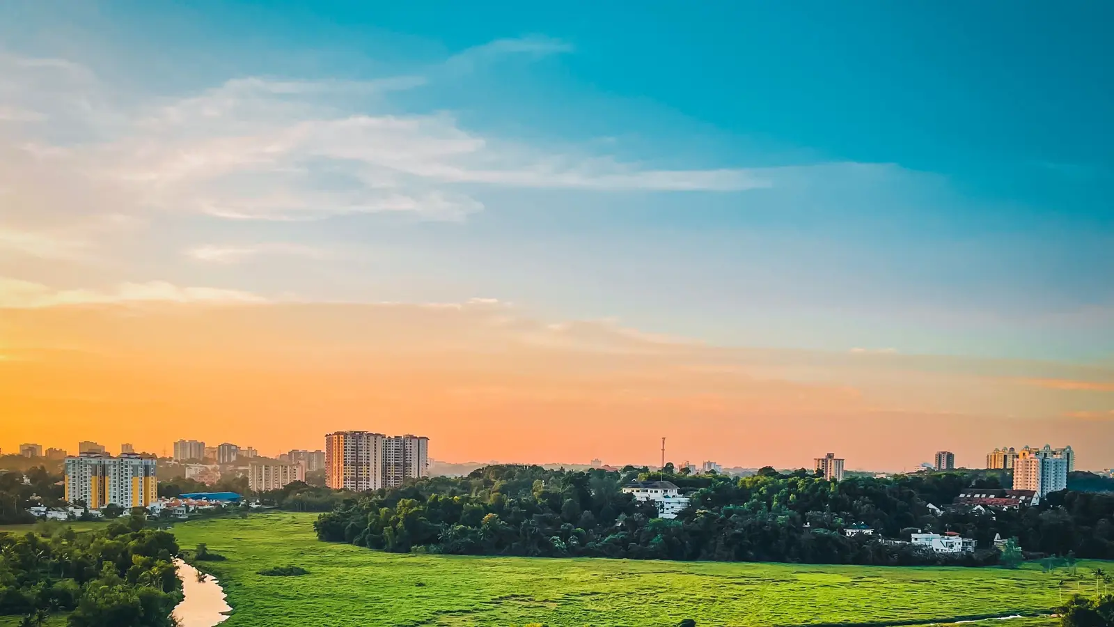 Kochi skyline at sunset across the green Kochi backwaters